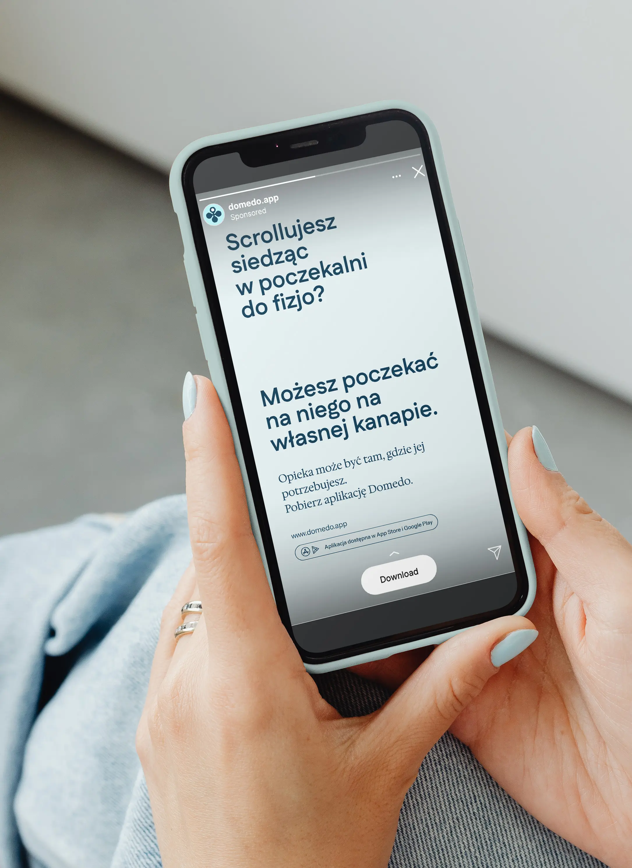 hand holding a phone displaying an Instagram ad with text “Scrolling in your physio’ waiting room? You could wait for them on your own couch.”